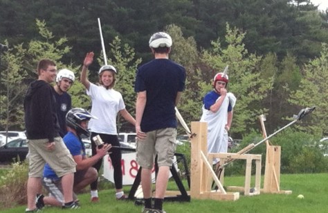 Teams used medieval-style slingshots and catapults that they built to try to hit a target.
